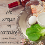 Pesach platter display with quote "We conquer by continuing"